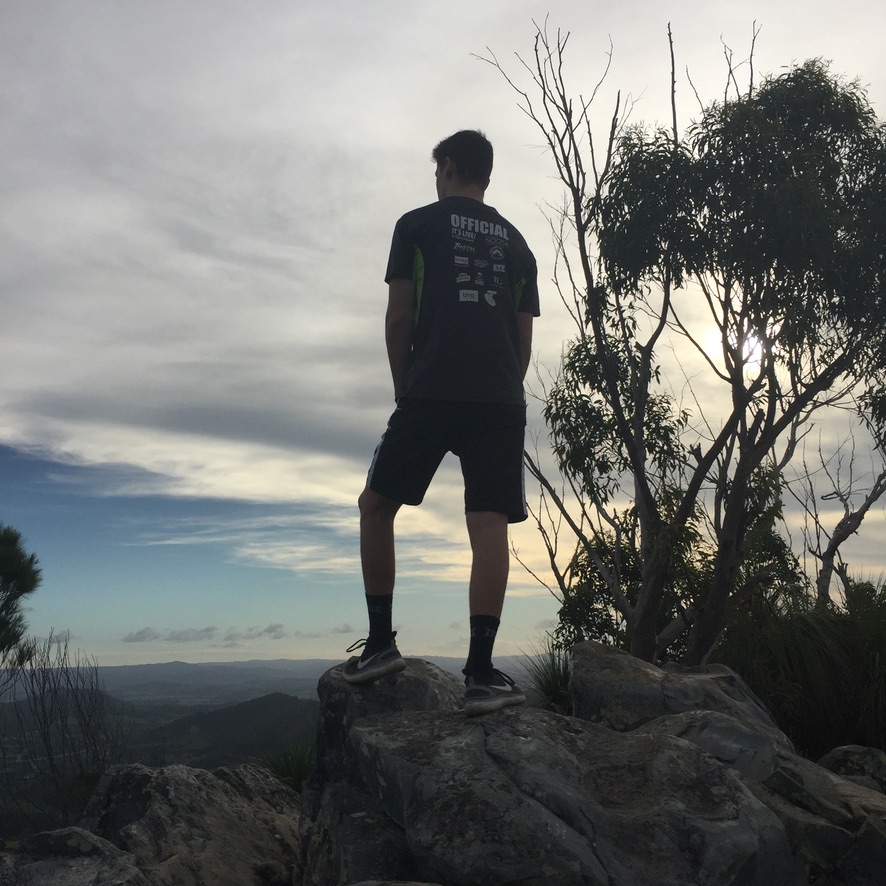 Young person on rocks looking out over the landscape